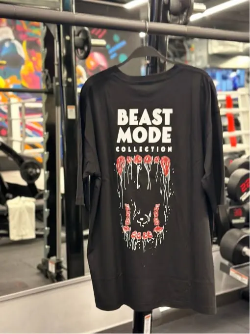 Black long-sleeve tee on a gym rack, Beast Mode Collection drip lettering