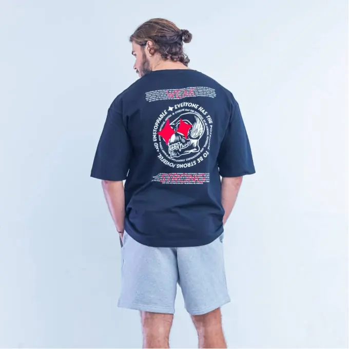 Navy tee worn from behind with a circular back print