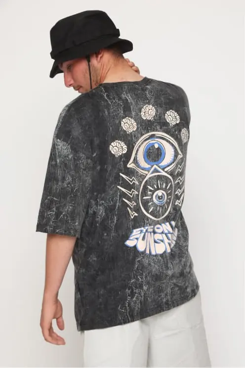 Washed grey tee worn from behind, eye and floral back print