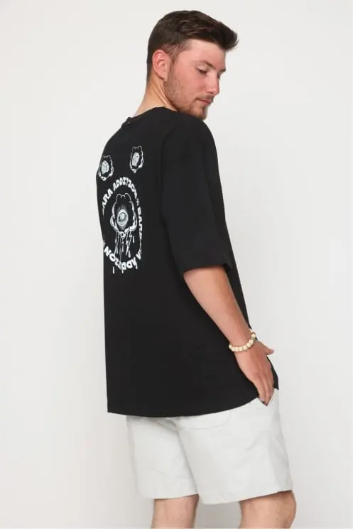 Black tee worn from behind with a circular emblem back print