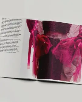 A book spread with a magenta fabric insert